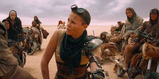 Furiosa (Charlize Theron) kneels in front of the wives in 'Mad Max: Fury Road'