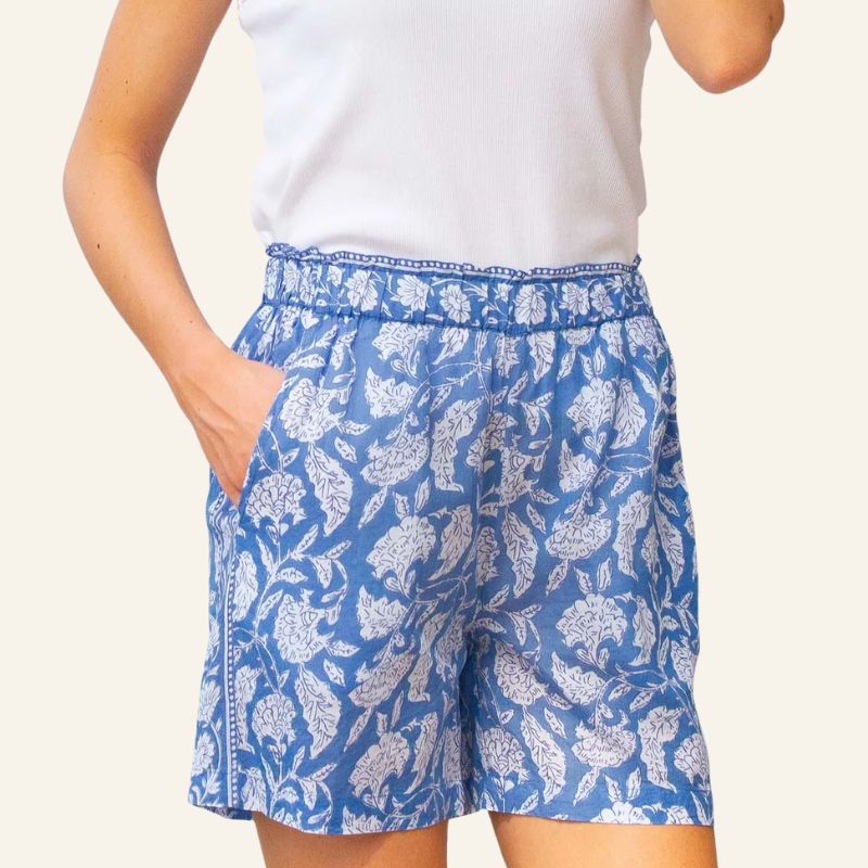 A model wears blue and white shorts by Aspiga