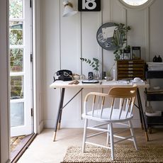 room with white walls white desk and table with chairs