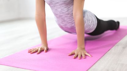 yoga vs pilates: woman doing up dog