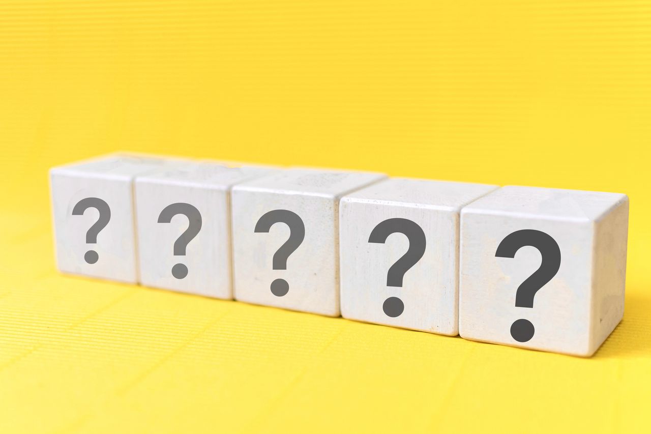 Question mark symbol on wooden blocks with yellow background