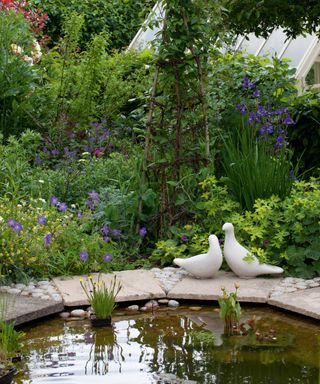 garden pond with bird ornaments