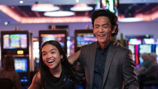 Mia Isaac (as Wally) and John Cho (as Max) at a casino in Don't Make Me Go