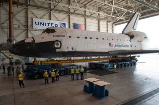 Space shuttle Endeavour is seen atop the Over Land Transporter in a hangar at Los Angeles International Airport.