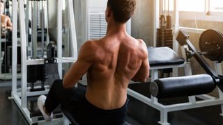 A man using the cable row machine in the gym