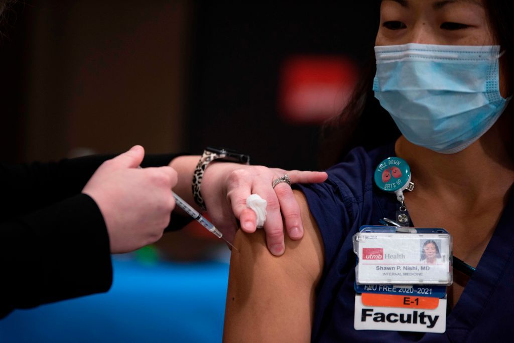 Doctor Shawn Nishi receives the Covid-19 vaccine at John Sealy Hospital at the University of Texas Medical Branch