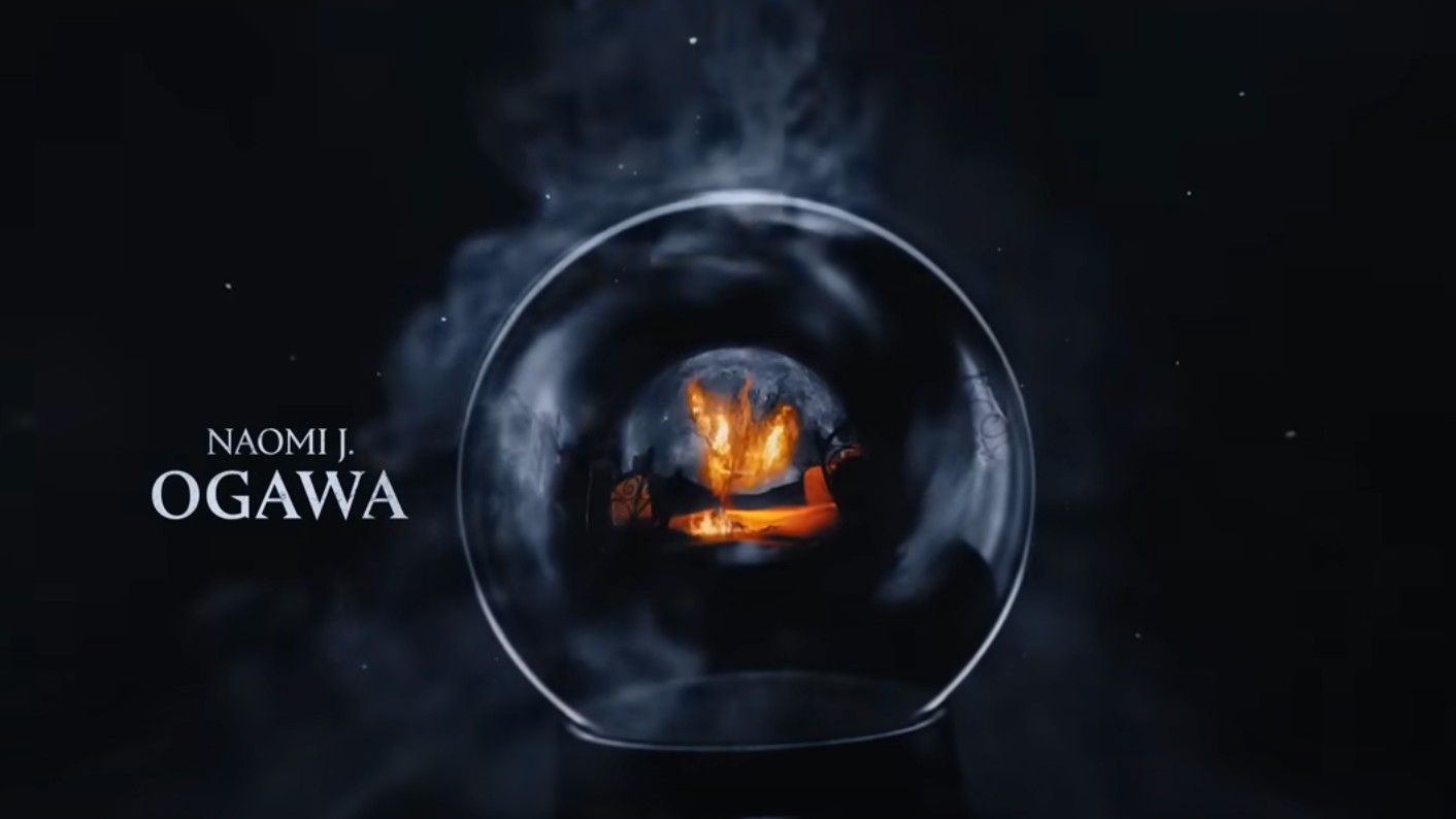 The credit for Naomi J. Ogawa is shown next to a burning scene inside of a glass orb.