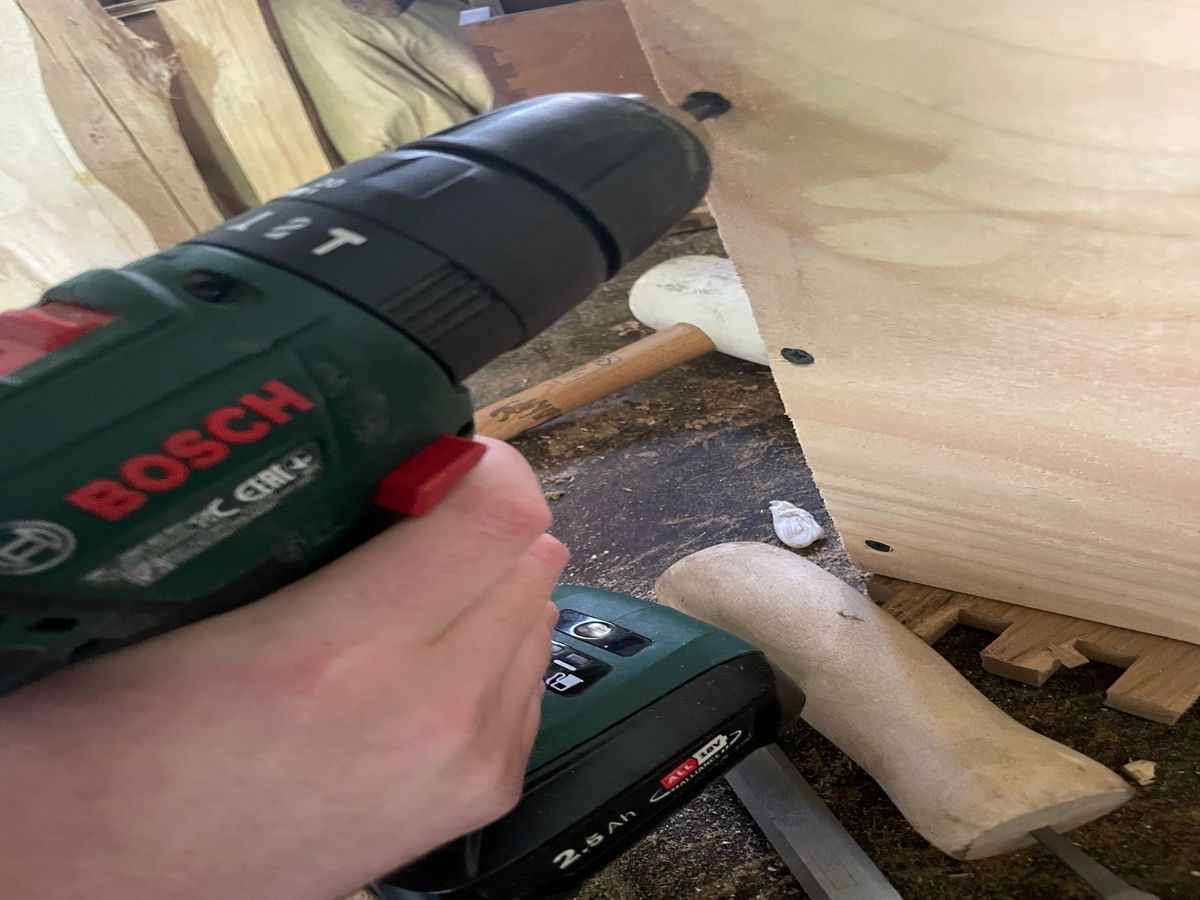 A Bosch screwdriver screwing into wood