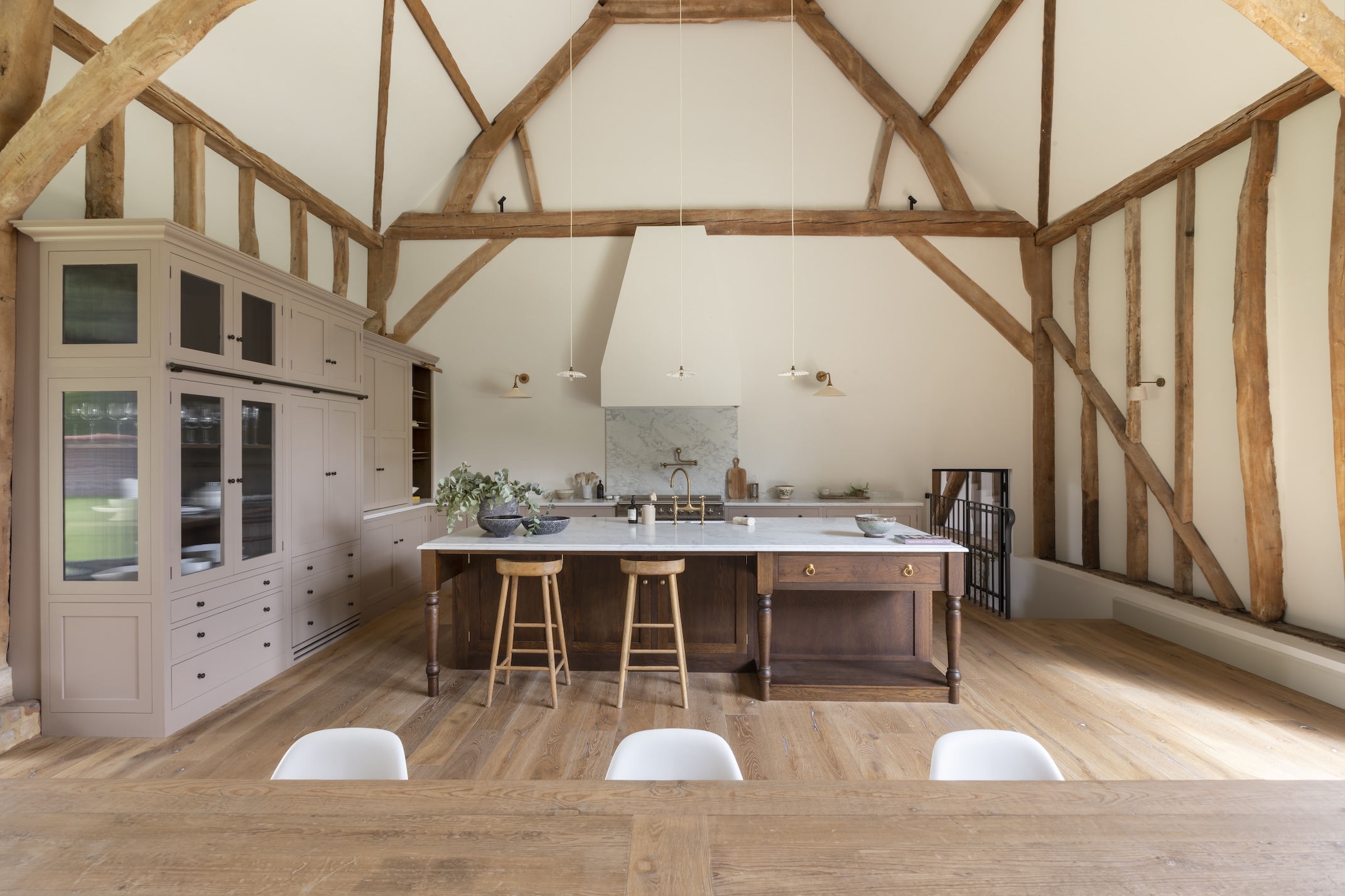 A barn conversion kitchen with exposed beams and mixed wood finishes.