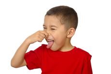 Young boy holding his nose.