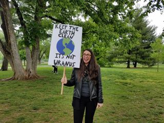Kat Fanning, a librarian from Jersey City, New Jersey, holds a sign made by her cousin during the March for Science at Washington D.C. on April 22, 2017.