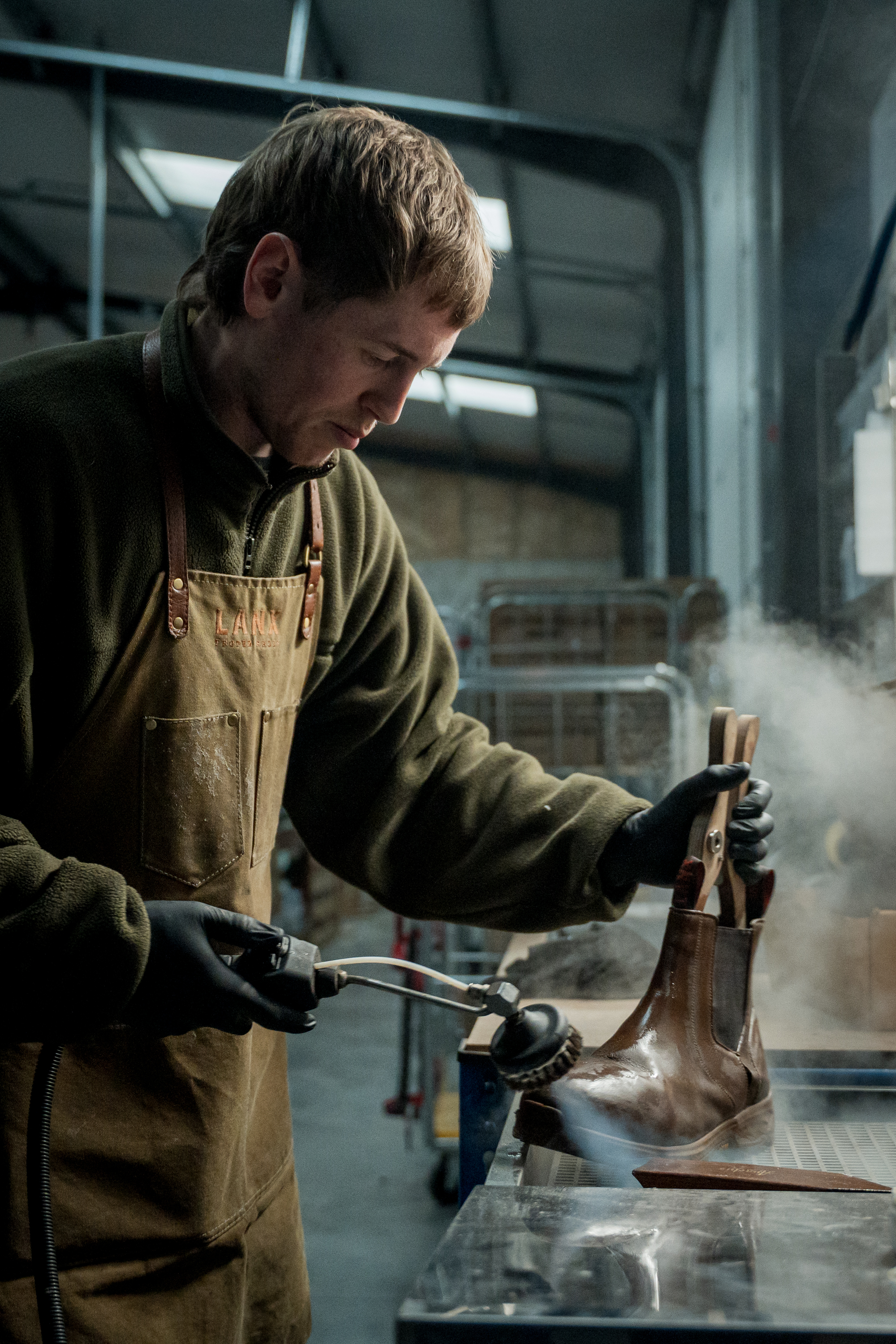 an image of one of the boot-makers at Lanx repairing one of their Chelsea boots
