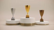 Three trophies on pedestals.