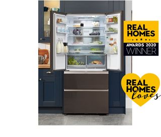 Haier HB18FGSAAA French Door Fridge Freezer open with food and drinks in, in a kitchen with dark blue cupboards
