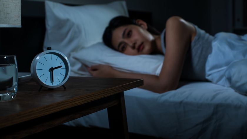 Young woman is wide awake at night and wants to fall back to sleep fast