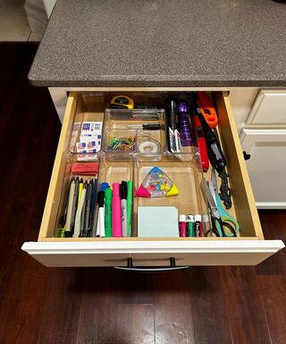 Organised drawer with stationery items visible