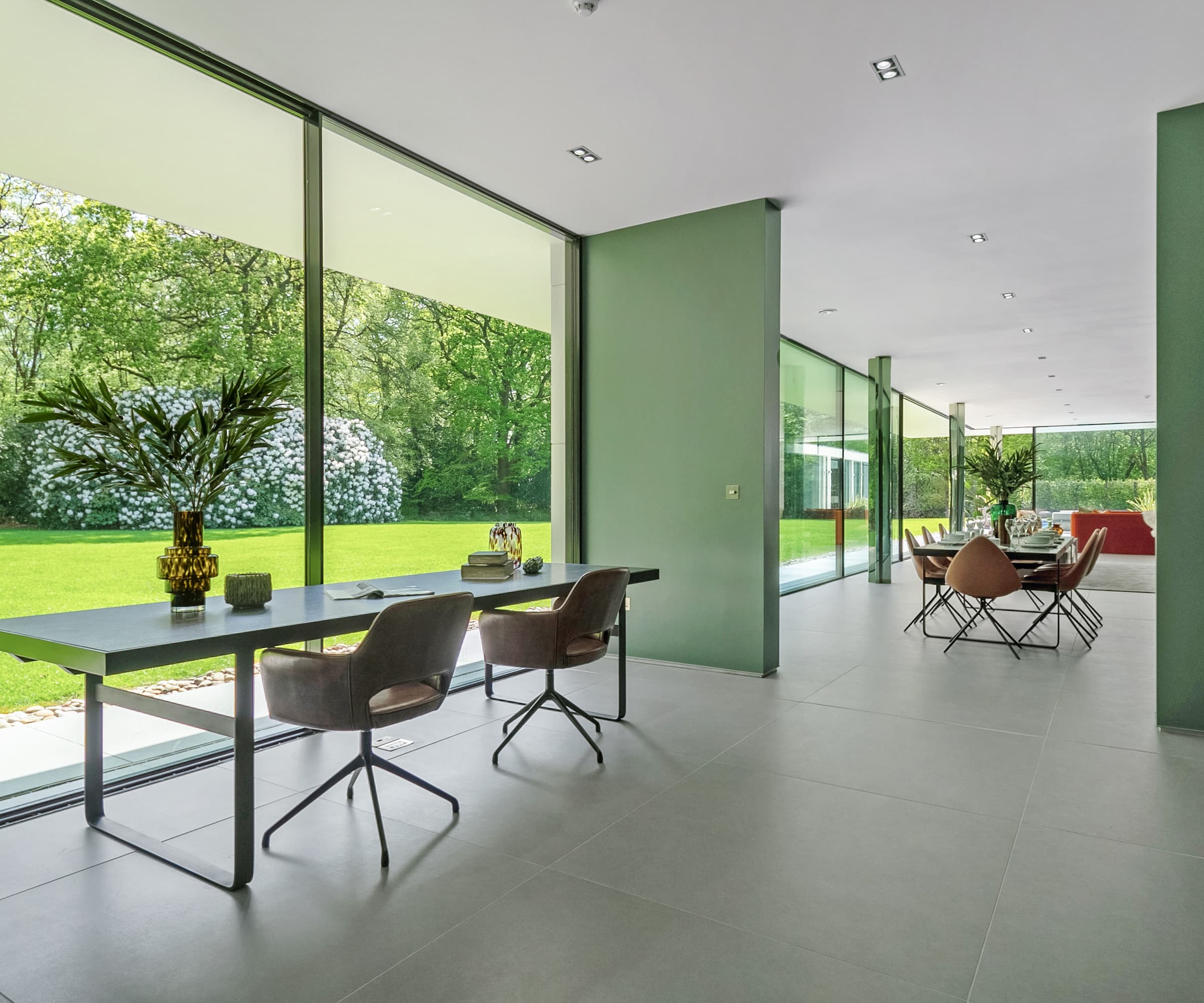 Large picture windows looking onto a garden next to an office