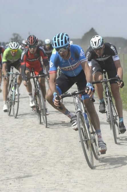Britain's David Millar (Garmin-Sharp) rides in the pack (C) through a cobblestoned section