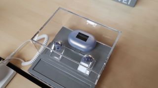 Huawei FreeBuds Pro 2 blue earbuds and case inside a glass display case