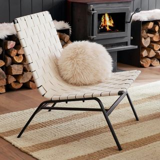 Shay Upholstered Armchair on a white and beige carpet. 