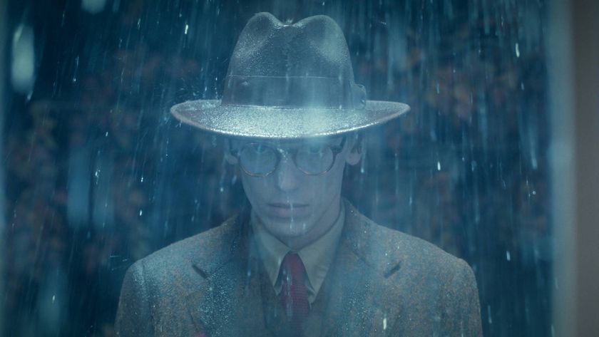 Jamie Campbell Bower as Mr. Whatsit in Stranger Things season 5 volume 2, standing in the rain wearing a rimmed hat