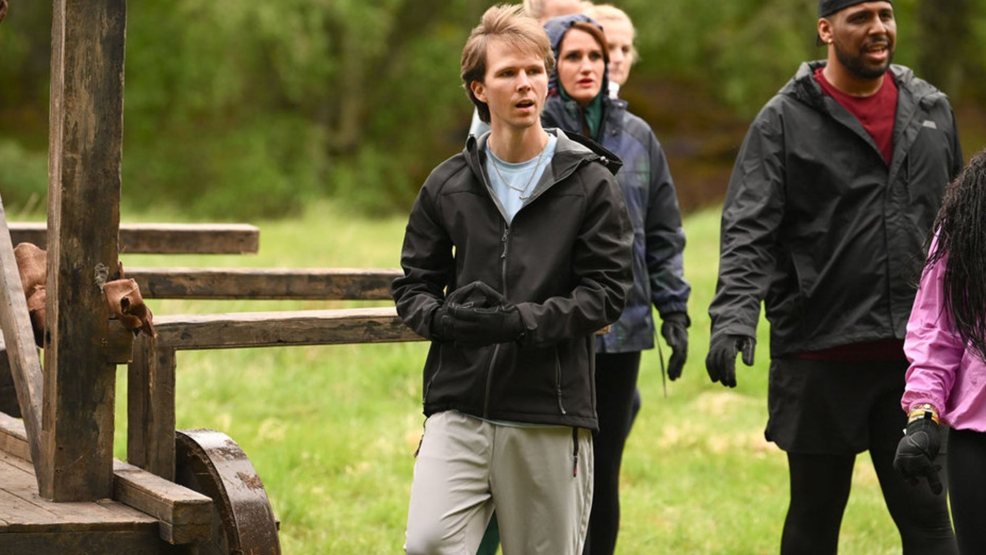Logan during the competition reacting in shock as the rest of the Faithful look on at the other competitors in action.
