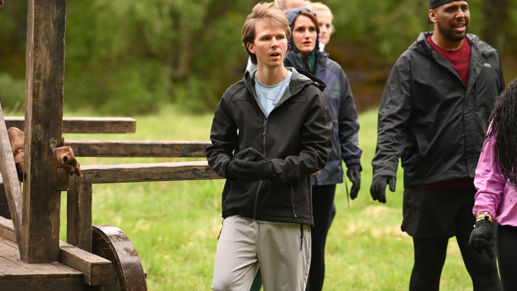 Logan during the competition reacting in shock as the rest of the Faithful look on at the other competitors in action.