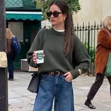 woman in olive green sweater and jeans