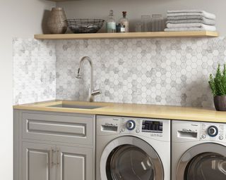 undermount laundry room sink by ruvati in a laundry room with washing machine and tumble dryer
