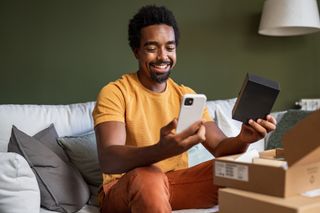 A man opening a new phone received as a gift.