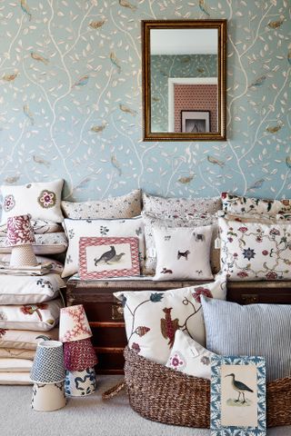 store room in London Victorian home with cushions prints and bird wallpaper