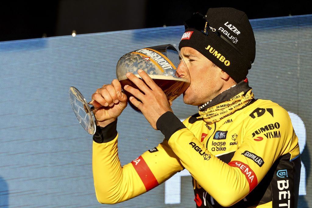 Belgian Tiesj Benoot of JumboVisma drinks as he celebrates on the podium after winning the KuurneBrusselsKuurne one day cycling race 193 km from Kuurne to Kuurne via Brussels in Kuurne on February 26 2023 Photo by DAVID PINTENS Belga AFP Belgium OUT Photo by DAVID PINTENSBelgaAFP via Getty Images
