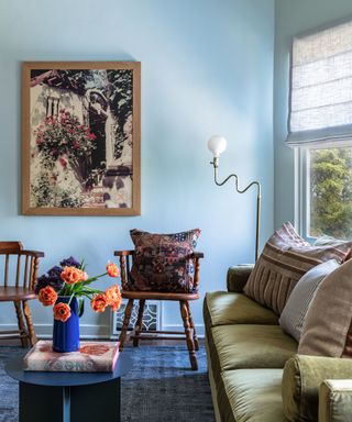 blue living room with artwork on walls