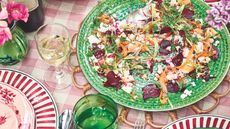 Pickled vegetables and ricotta on a green plate on a pink and white gingham tablecloth with green and pink accessories