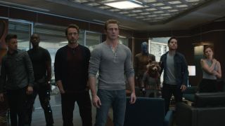 From left to right: Hawkeye, War Machine, Iron Man, Captain America, Nebula, Rocket, Ant-Man and Black Widow standing together out of uniform in Avengers: Endgame.