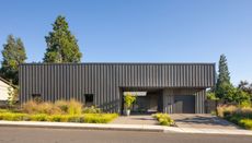 meadow house in oregon against blue skies with its grey, low orthogonal volume