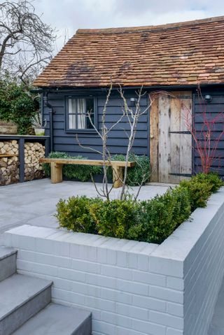 modern garden with grey stone wall