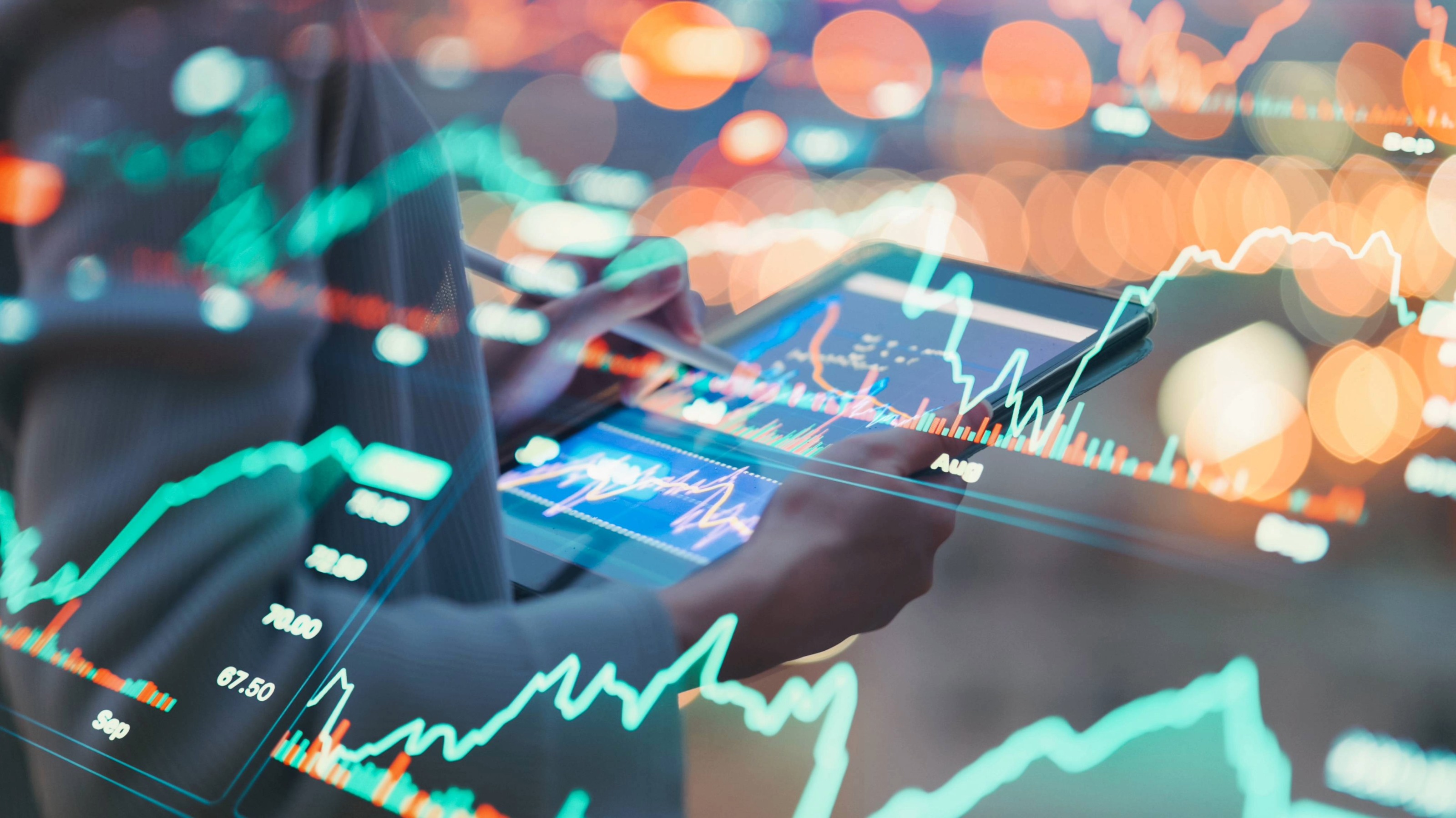 Chart graphics overlaying an image of a woman holding a tablet with more charts on the screen