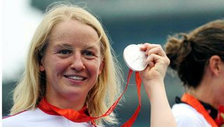 Emma Pooley holds up her silver medal at the 2012 Olympics