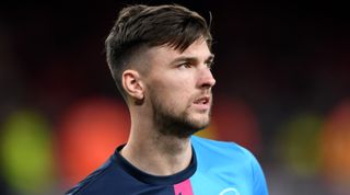 Kieran Tierney of Arsenal looks on while warming up ahead of the Premier League match between Arsenal and West Ham United at the Emirates Stadium on 26 December, 2022 in London, United Kingdom.