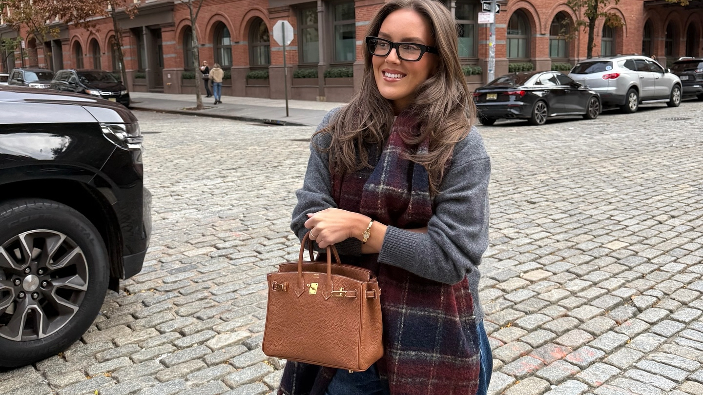 Emma Leger in a grey sweater and plaid scarf