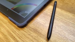 XPPen Magic Drawing Pad; a stylus next to a drawing tablet on a wooden table