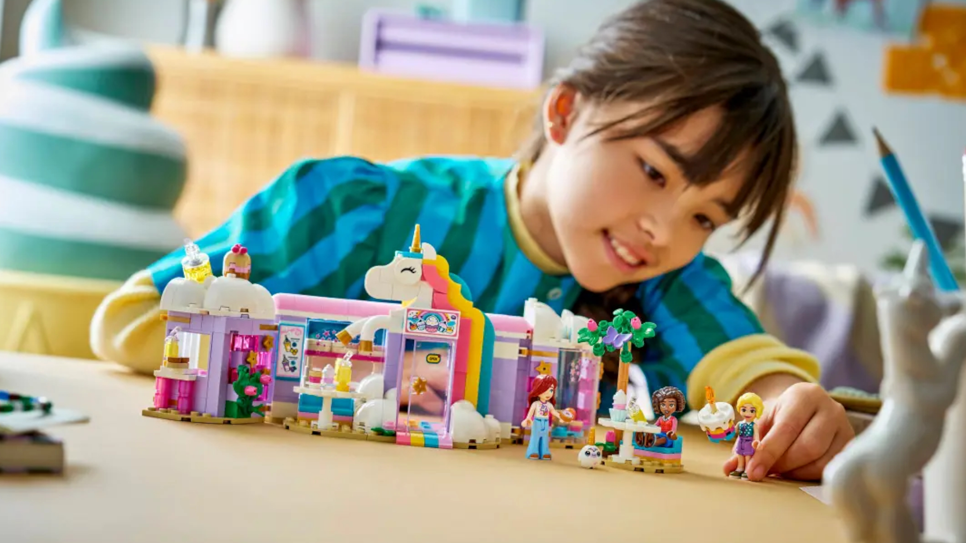 A child plays with a Lego unicorn-themed set
