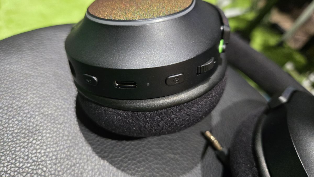 The Razer Barracuda X Chroma wireless gaming headset with a colorful finish on a chair.
