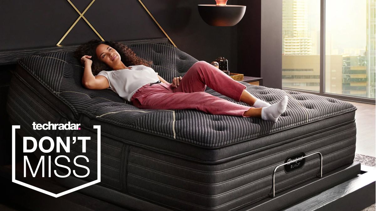 A person reclining on a Beautyrest Black mattress in a bedroom