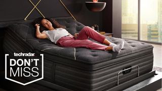 A person reclining on a Beautyrest Black mattress in a bedroom