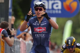 Team AlpecinFenix rider Belgiums Tim Merlier C celebrates as he crosses the finish line to win the second stage of the Giro dItalia 2021 cycling race 179 km between Stupinigi and Novara Piedmont on May 9 2021 Photo by Luca Bettini AFP Photo by LUCA BETTINIAFP via Getty Images