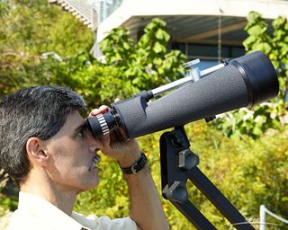 Celestron SkyMaster 25x100 can only be used on a tripod or counterweighted arm. Here, the author scans for the moon in daylight.