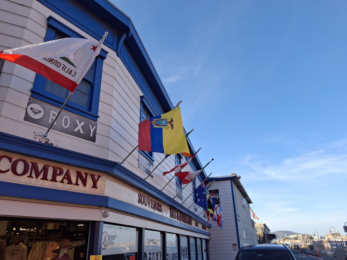 Flags flying outside a souvenir shop shot by the Galaxy A35