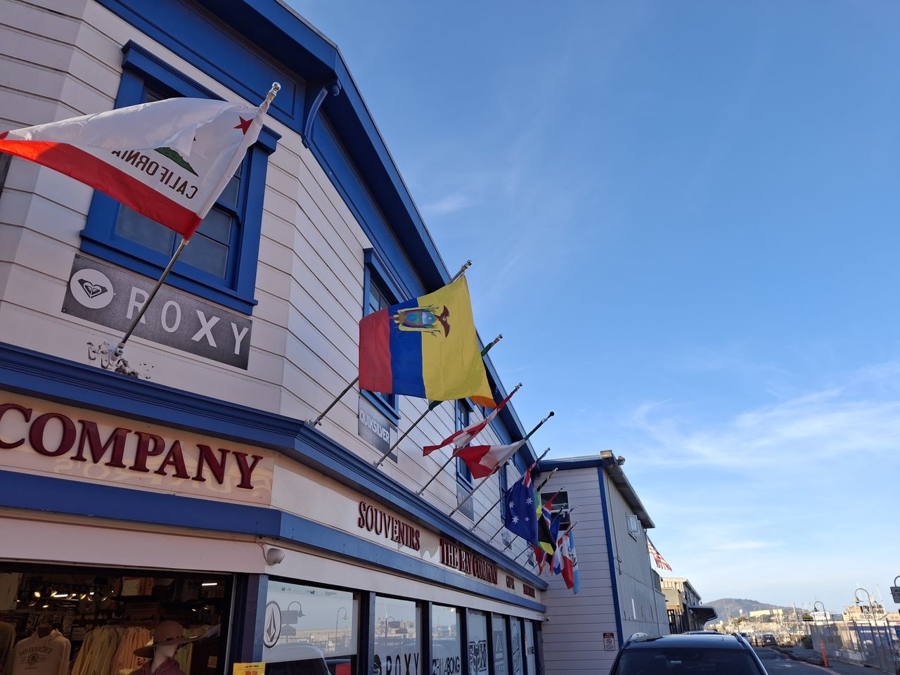Flags flying outside a souvenir shop shot by the Galaxy A35